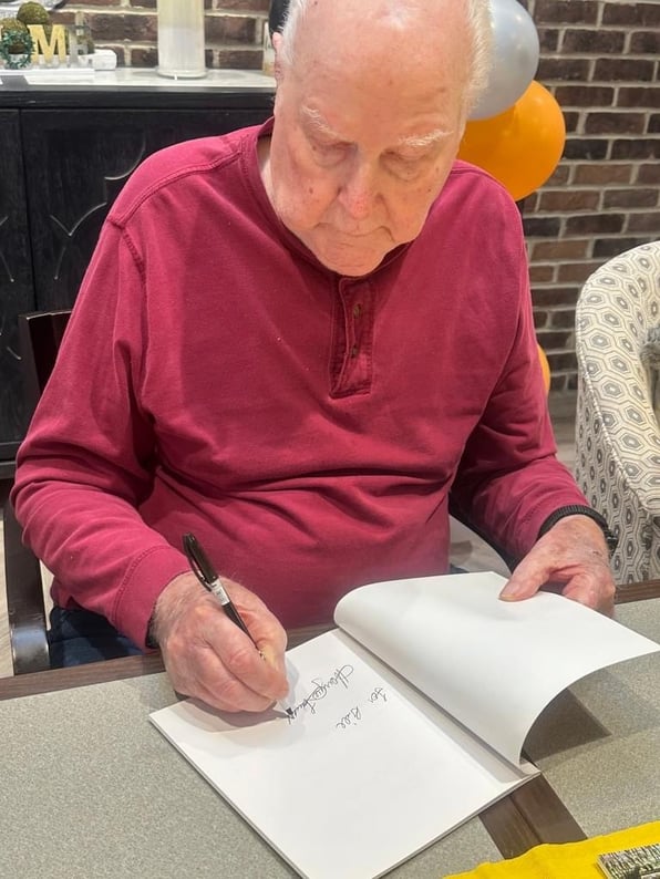 Dad signing his book 