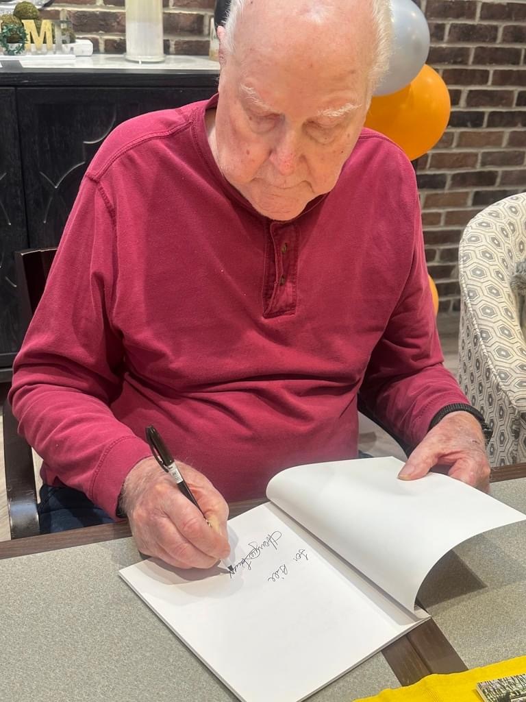 Dad signing his book 